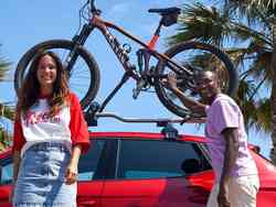 Friends next to a seat ibiza red desire colour with a bike rack accessory